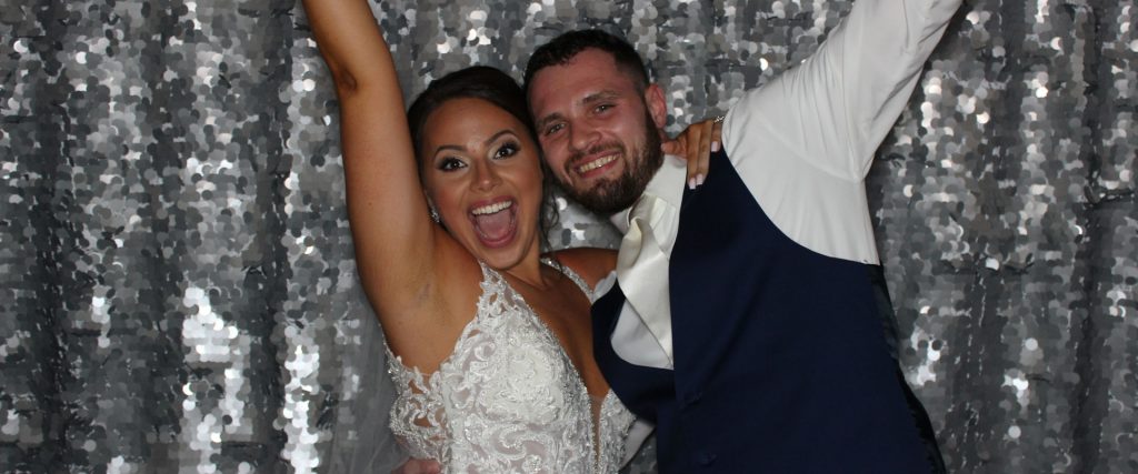 Bride and Groom Celebrating in a Wedding Photo Booth