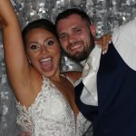 Bride and Groom Celebrating in a Wedding Photo Booth