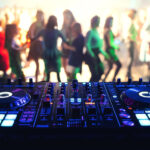 music controller DJ mixer in a night club at a live electronic music concert